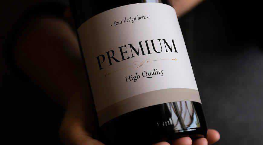 Person Holding Wine Bottle Photoshop PSD Mockup Template