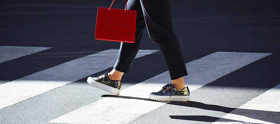 A person walking with a shopping bag.