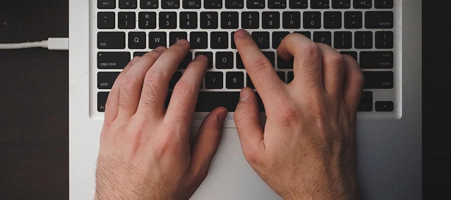 A person types on a keyboard.
